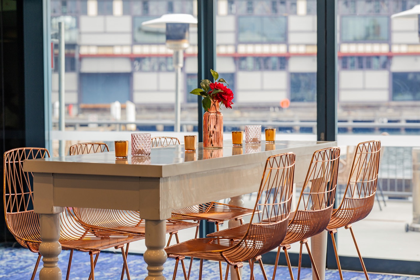 Dawes Point Rooms at Pier One with copper chairs and floor to ceiling windows over Walsh Bay