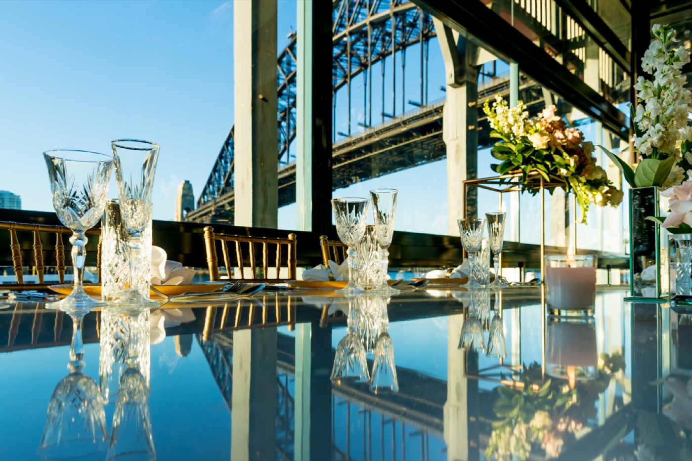 The Water Room at Pier One set for dining with harbour views through wrap-around glass