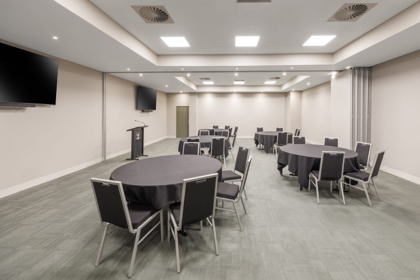 The Big Room with screen and round tables