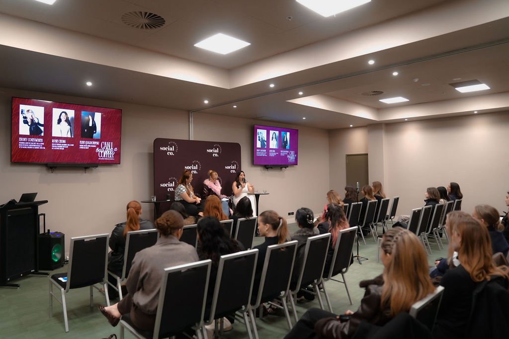 Audience seated theatre-style for a panel presentation