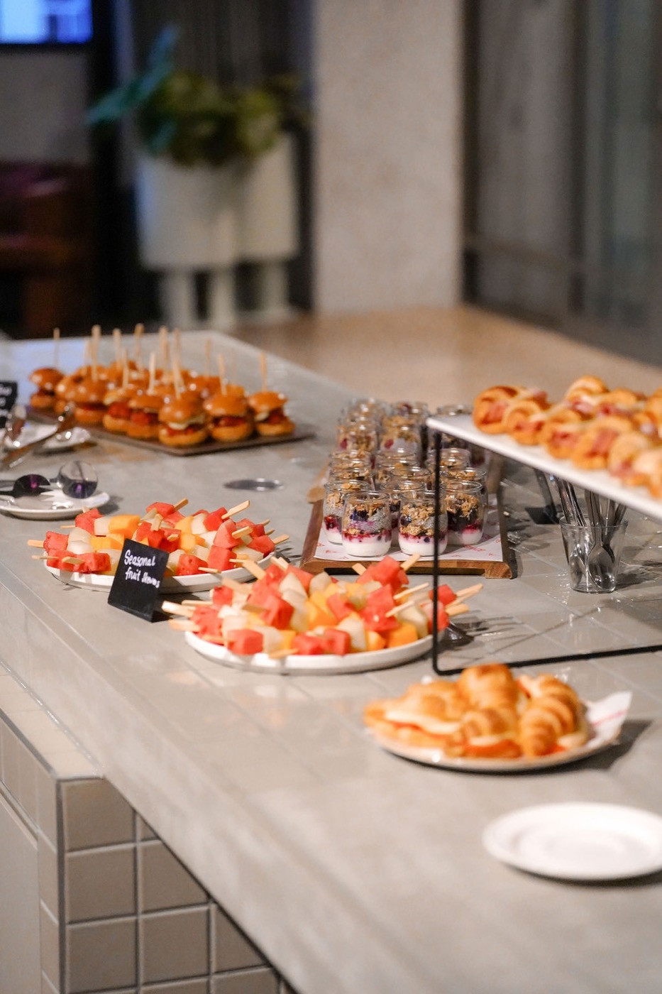 Close-up canapé and seasonal fruit skewer spread